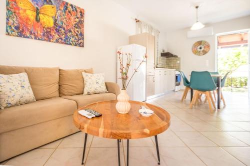 a living room with a couch and a table at Porto Gerakas Villas in Vasilikos