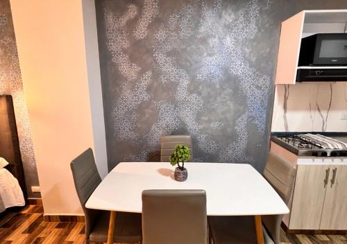 a kitchen with a table with a potted plant on it at PARK 66 Apartaestudios in Cali