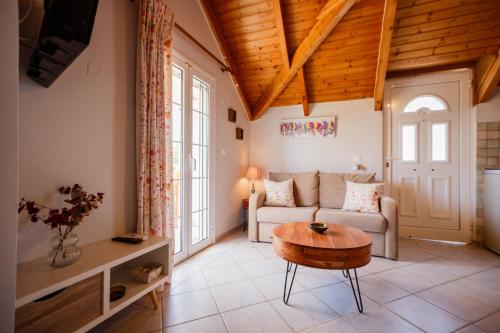 a living room with a couch and a table at Porto Gerakas Villas in Vasilikos