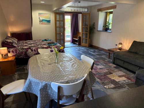 a living room with a table and a couch at The Shippon at RoseHip in Launceston
