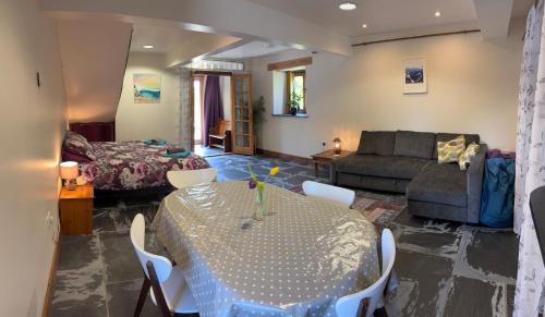 a living room with a table and a couch at The Shippon at RoseHip in Launceston