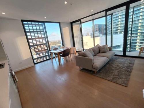 a living room with a couch and a table in a building at Luxury Apartment St Leonards in Sydney