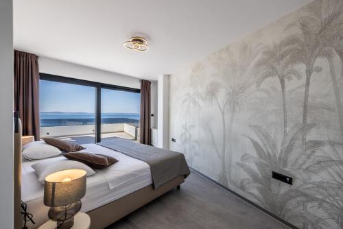 a bedroom with a mural of palm trees on the wall at Seaside Villa Leonis - Gym, Sauna and a pool in Podstrana