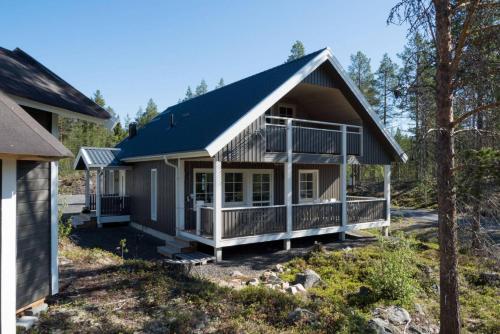 a house with a gambrel roof and a porch at Sauna cabin | Pets allowed | Engine heater in Lofsdalen
