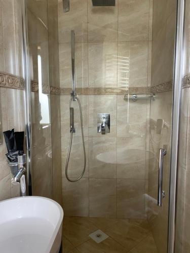 a bathroom with a shower with a toilet and a sink at Едем in Brzezhany