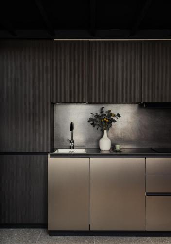 a kitchen with a sink and a vase of flowers at Bellevue Bocconi Suite in Milan