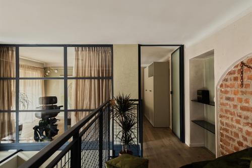 a room with a staircase and a brick wall at Bellevue Bocconi Suite in Milan