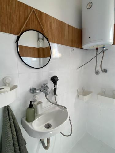 a bathroom with a sink and a mirror at Saint Sunday in Kamenari