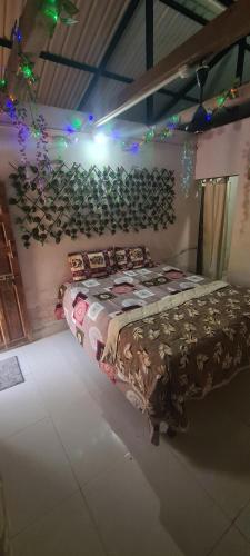 a bedroom with a bed in a room with lights at Pratishant Village Home Stay & Agro Tourism in Jāmb