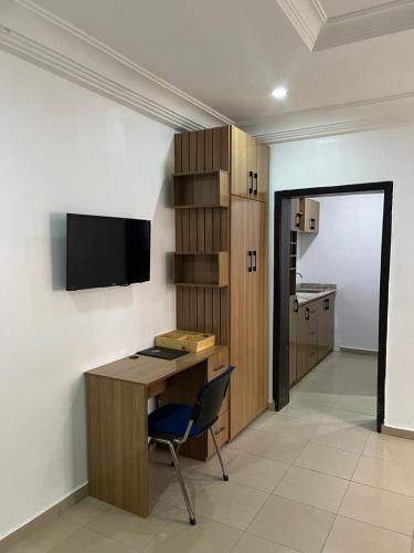 a office with a desk and a chair in a room at Events & Suites in Abuja