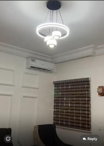a room with a ceiling with a window and a chandelier at Events & Suites in Abuja