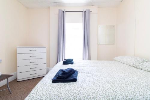 a bedroom with a white bed and a dresser at Brookvale Guest House Room 10 in Southampton