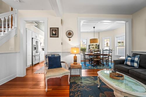 a living room with a couch and a table at Historic Seaside Downtown Mystic Home Walk to Seaport in Stonington