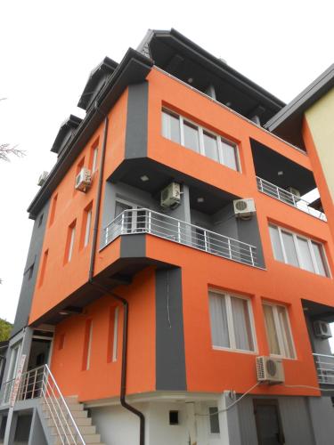 an orange building with balconies on the side of it at Villa Angel Apartments - OHRID- in Ohrid