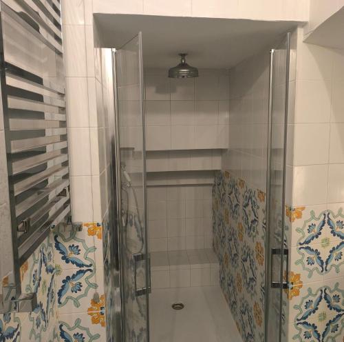 a shower with a glass door in a bathroom at The Crown Palace - Gallipoli in Gallipoli