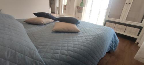 a bedroom with a bed with pillows on it at La Torre Guest House in Anguillara Sabazia
