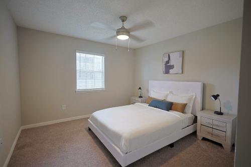 a white bedroom with a white bed and a window at Northtown Apartments 15f I Spacious 1 Bed 1 Bath in Jackson