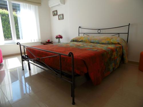 a bedroom with a bed with a red comforter at Sunny Villa with Terrace in Comerio