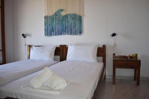 a bedroom with two beds and a table and a picture at Macrame House Zakynthos in Vasilikos