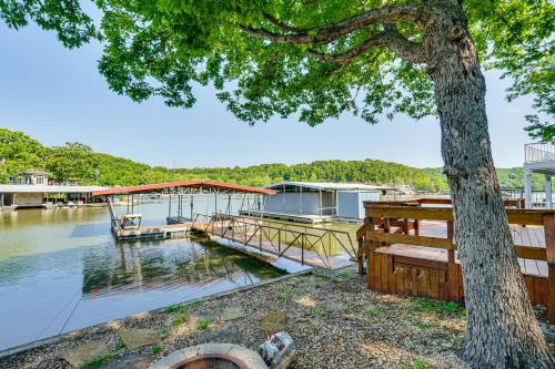 a dock with a boat on the water at Private Dock on Fishing Cove Camdenton Getaway in Camdenton