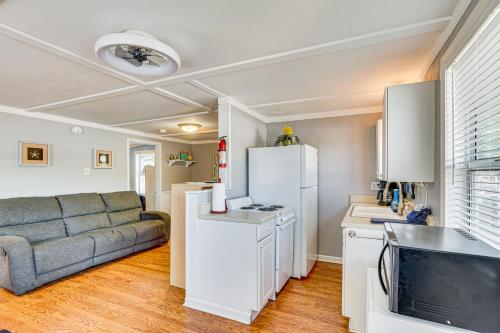 a living room with a couch and a kitchen at Private Dock on Fishing Cove Camdenton Getaway in Camdenton
