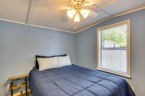 a bedroom with a bed and a ceiling fan at Private Dock on Fishing Cove Camdenton Getaway in Camdenton