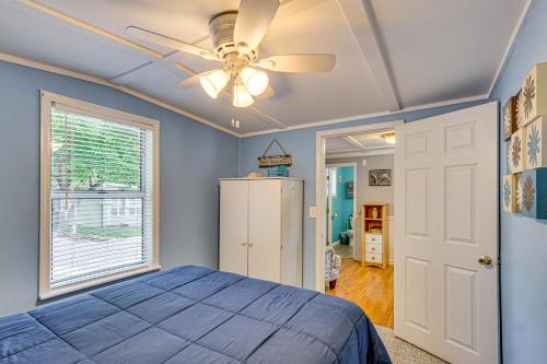 a bedroom with a blue bed and a ceiling fan at Private Dock on Fishing Cove Camdenton Getaway in Camdenton