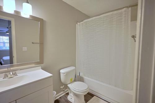 a bathroom with a toilet and a sink and a mirror at Northtown Apartments 12h I Comfy 2 Bed 2 Bath in Jackson
