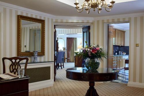 a living room with a vase of flowers on a table at Cheval Thorney Court at Hyde Park in London
