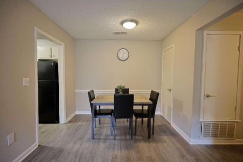 a dining room with a table and chairs and a black refrigerator at Northtown Apartments 15f I Spacious 1 Bed 1 Bath in Jackson