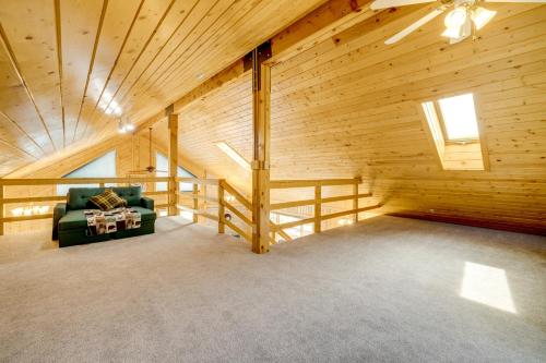 a living room with a green couch in a wooden building at Walk to Sinks Canyon State Park Spacious Home! in Lander