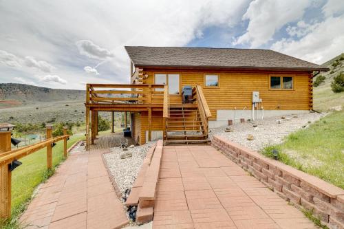 a log home with a deck and a staircase at Walk to Sinks Canyon State Park Spacious Home! in Lander