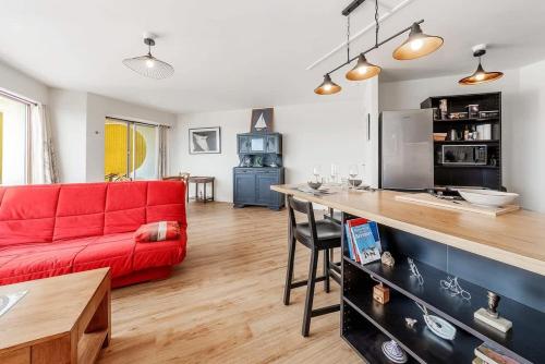 un salon avec un canapé rouge et une table dans l'établissement Bellevue, appartement T2, terrasse & parking, à Rennes
