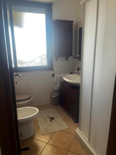 a bathroom with a toilet and a sink at Casa vacanze La Gioia in Sestu