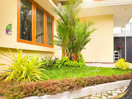 a house with plants in front of it at Palma Villa Homestay Klaten in Kuwoso