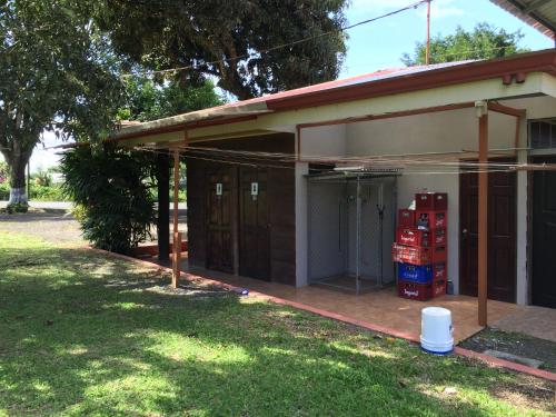 a house with a garage with a gas pump at Hotel Vale's in Chiles