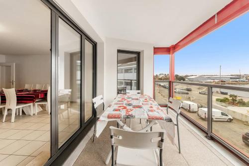 une salle à manger avec une table et des chaises sur un balcon dans l'établissement Le Camélia - Plage et Intra-muros - Parking, à Saint-Malo