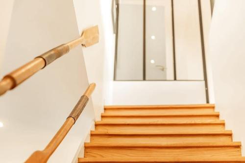 a staircase with wooden railings in front of a door at Albatros, grand duplex, 4 chambres, vue mer in Saint Malo