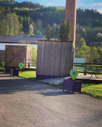 a group of benches sitting next to a fence at CHECKIN THE BOX Schloss Neubruck in Scheibbs