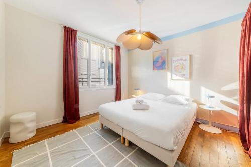 une chambre avec un lit blanc et une fenêtre dans l'établissement Vadrouille - Proche Mail - Parking - 4 personnes, à Rennes