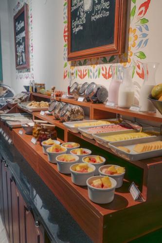 a buffet line with many plates of food on at Altipacha Ayacucho Hotel in Ayacucho