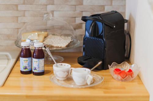 a counter top with a coffee maker and cups on it at Villa ElSi, Where Relaxation and Elegance Meet in Valenzano