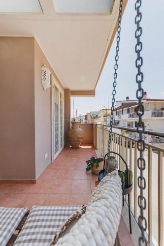 a porch with a hammock on a balcony at Villa ElSi, Where Relaxation and Elegance Meet in Valenzano
