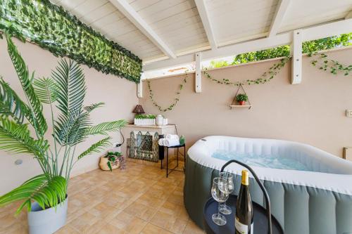 a bath tub in a room with a plant at Villa ElSi, Where Relaxation and Elegance Meet in Valenzano