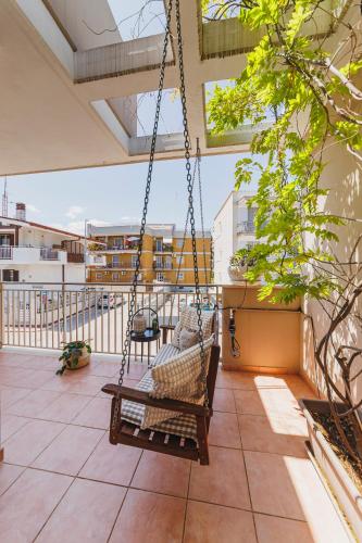 a swing on the balcony of a building at Villa ElSi, Where Relaxation and Elegance Meet in Valenzano