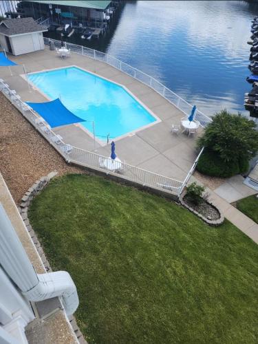 an overhead view of a swimming pool next to the water at Condo at Parkview Bay - Your Lakefront Oasis in Osage Beach