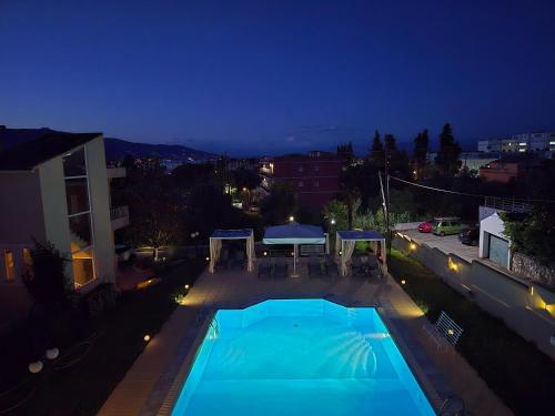 an overhead view of a swimming pool at night at Tranquil Apartments Corfu in Kontokali
