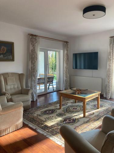 a living room with a couch and a coffee table at Vila Carpatina in Breaza