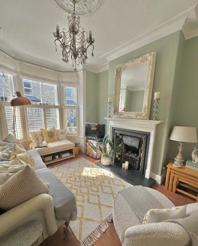a living room with a chandelier and a fireplace at City Apartments - 66 Scott Street in York