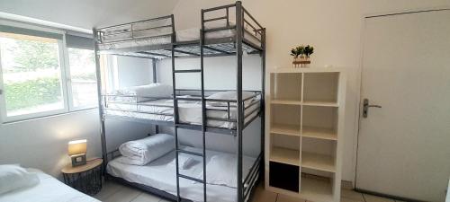 a room with three bunk beds and a bed at Gîte familial à Azay le Rideau avec Parking in Azay-le-Rideau